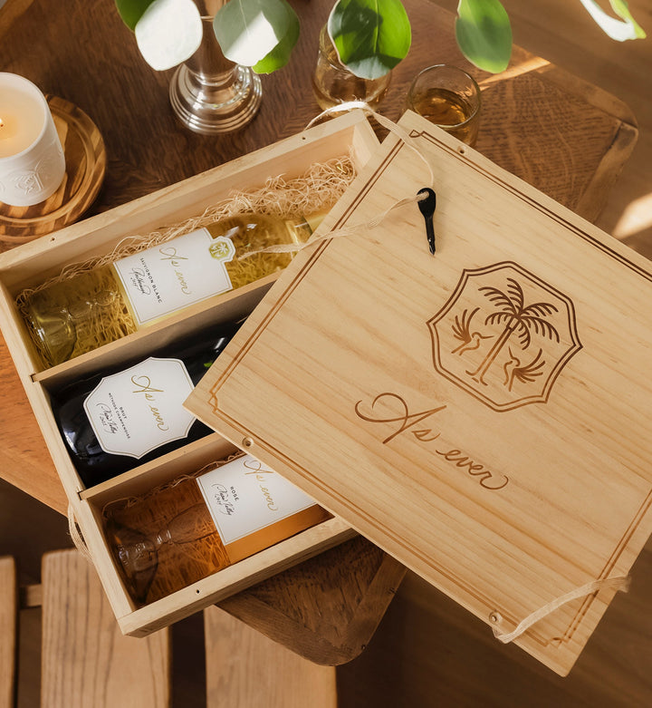 As ever wooden crate with engraved As ever logo and wine bottles inside on a wooden table